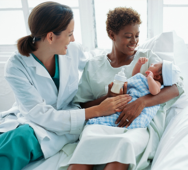 Woman and doctor looking at a baby